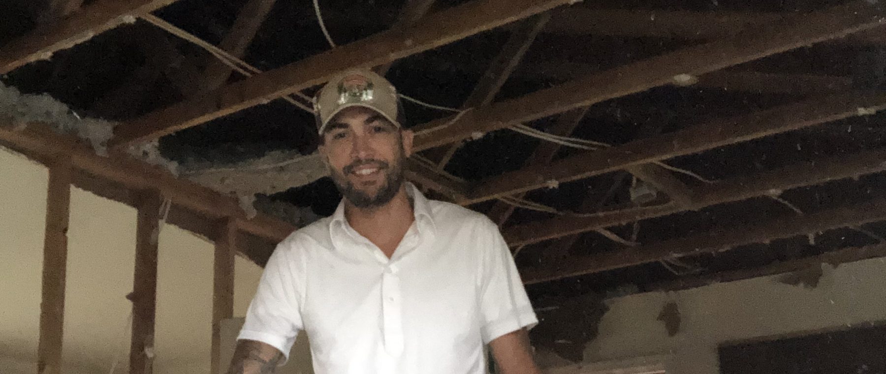 Steven on site inside a house stripped back to the framing
